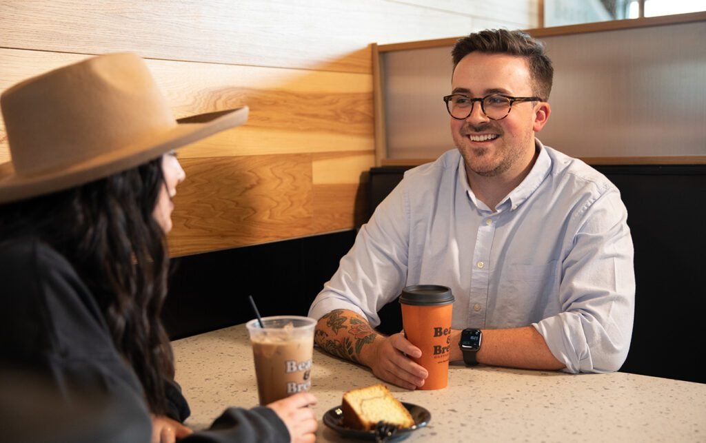 Friends talking over Beans & Brews coffee