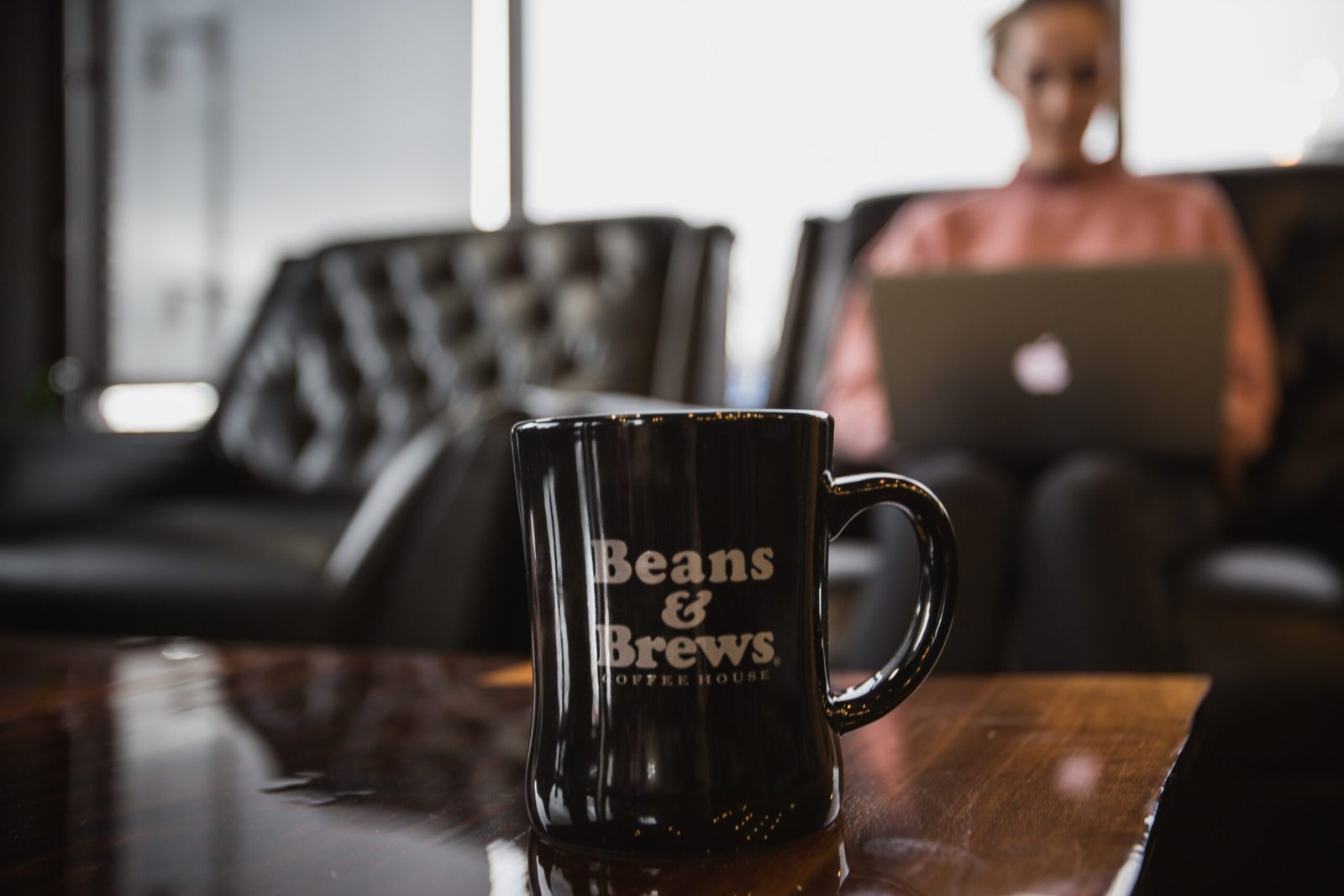 Beans and Brews coffee mug on a table