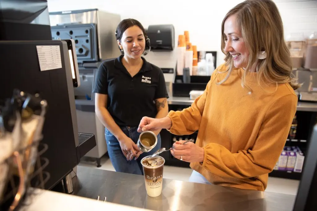 Beans and Brews employees pouring coffee