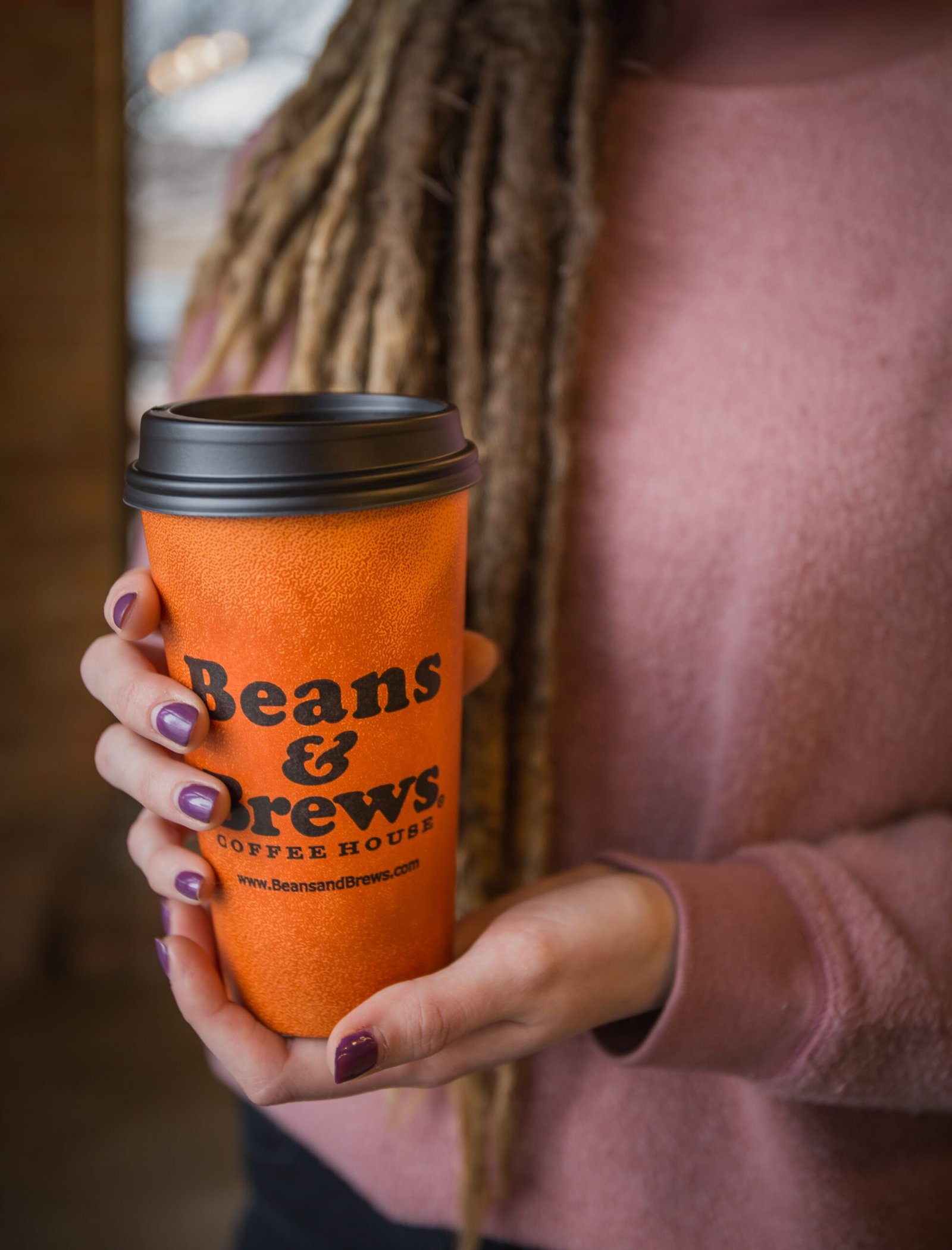 Close up of a woman's hands holding a coffee cup